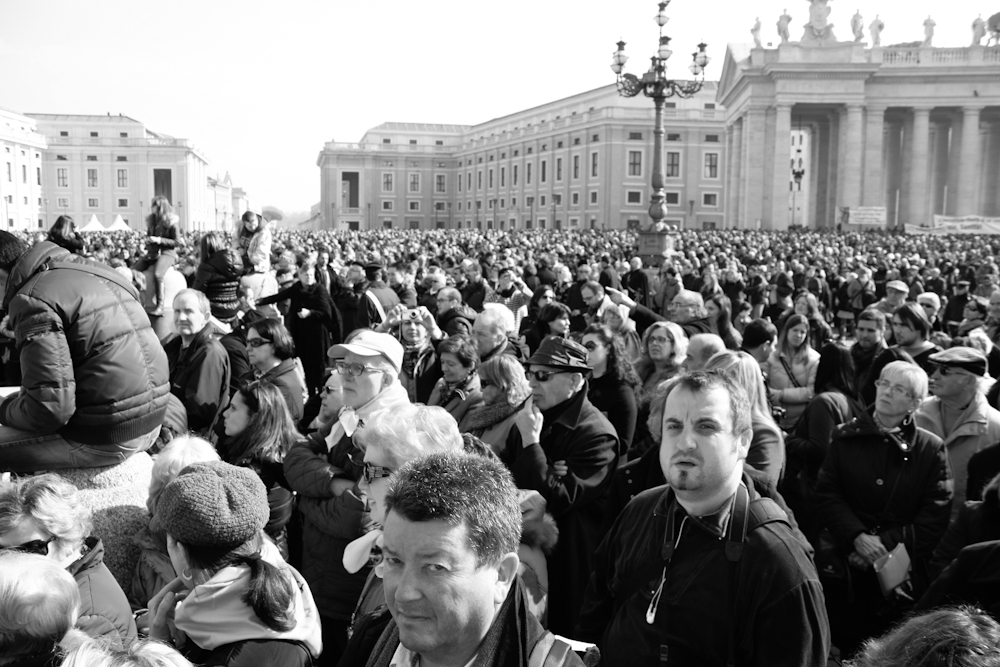 Crowds gather in Saint Peter's Square as Pope Benedict XVI appears on the balcony for one of his last Angelus prayers. Vatican, 2013