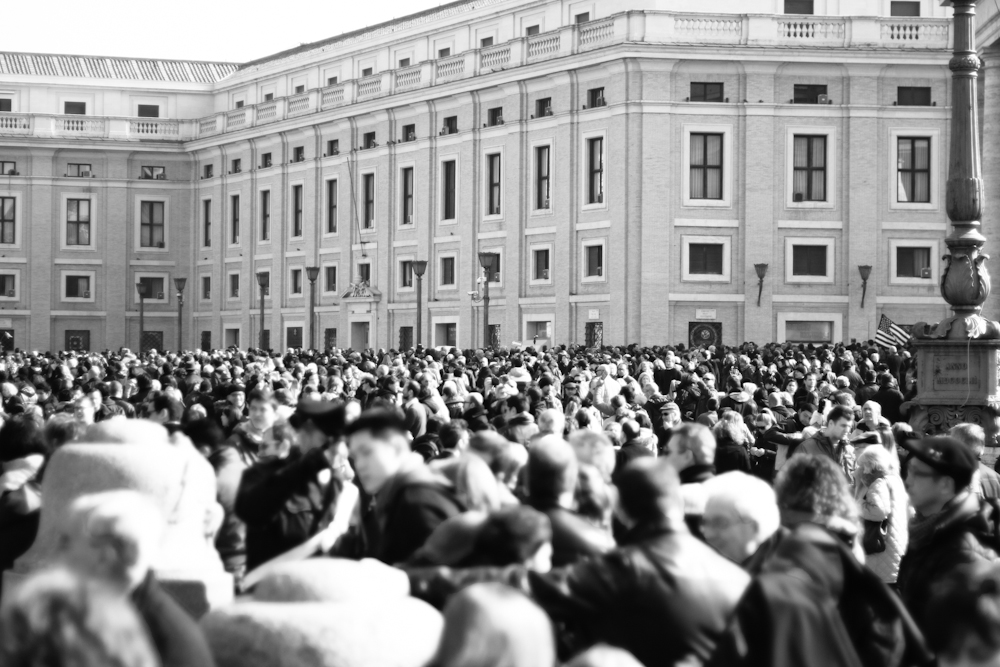 Crowds gather in Saint Peter's Square as Pope Benedict XVI appears on the balcony for one of his last Angelus prayers. Vatican, 2013